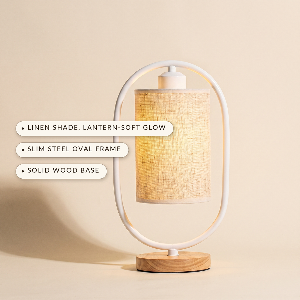 White oval frame table lamp showing linen shade, slim steel frame and solid wood base