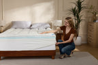 White bamboo cooling mattress topper on a bed