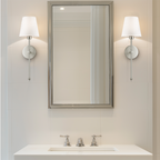 Wireless wall sconce mounted in a bathroom